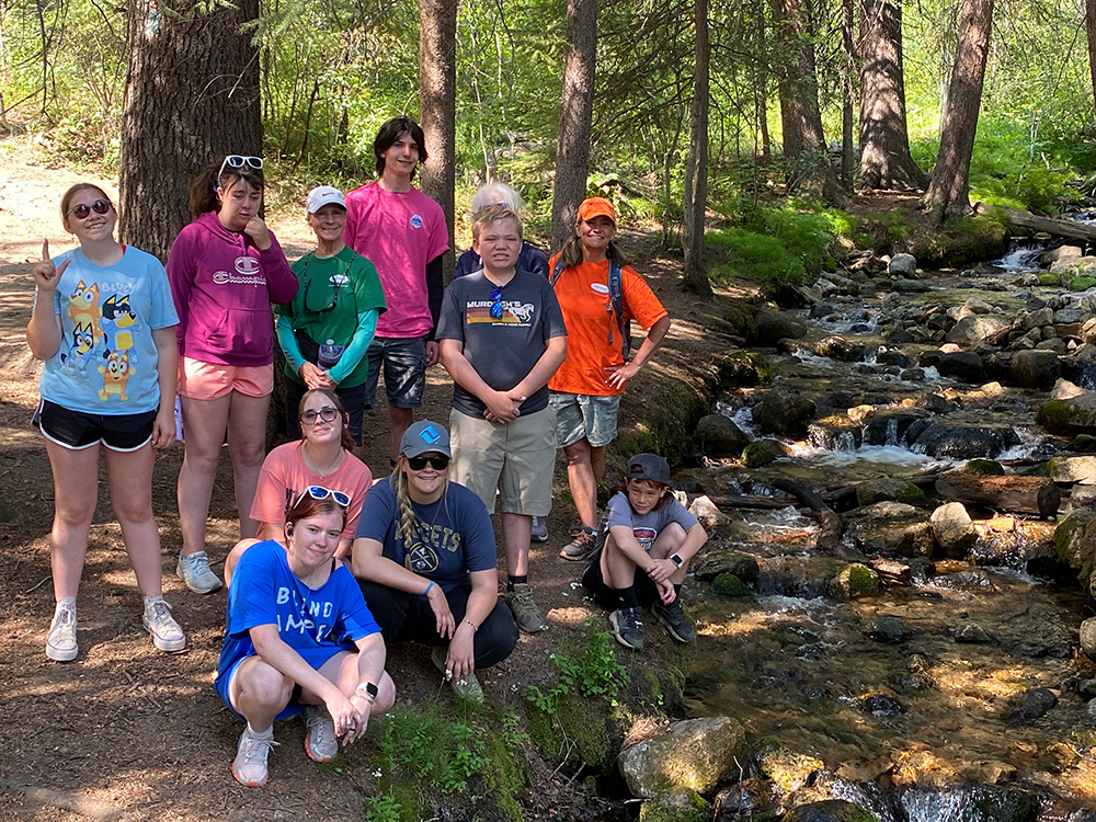Group of hikers near stream