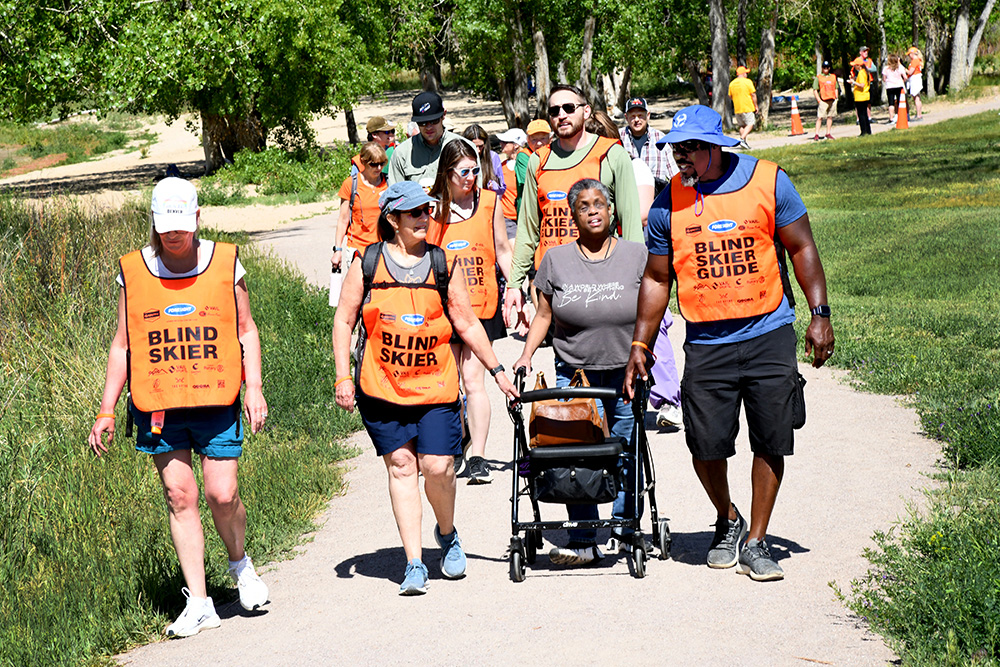 Guides supporting walker on trail
