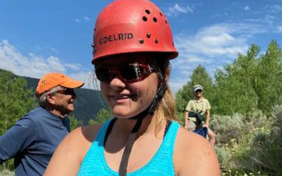 Ryan smiling and wearing a red helmet at summer camp