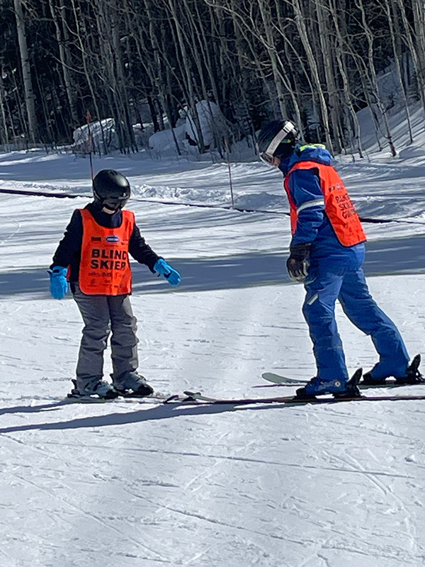 Instructor working with youth snowboarder